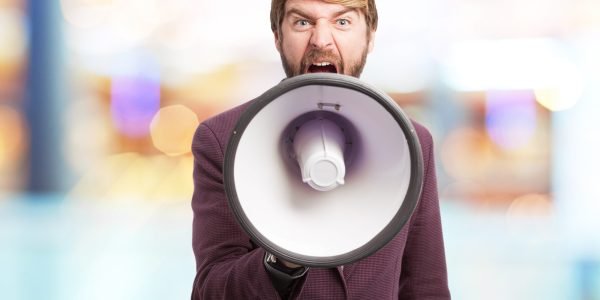 angry businessman with megaphone